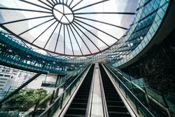 Two escalators underneath a sky light