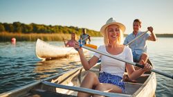 Woman smiling on a canoe with a group of friends