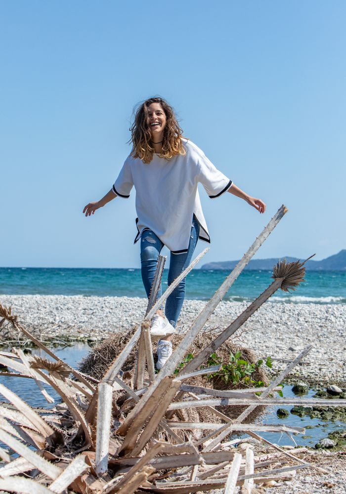 Young woman walking near dried plants