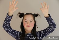 Portrait of an adorable child raising her arms up 4OpXEb