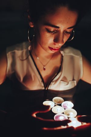 Woman swimming in pool with candles