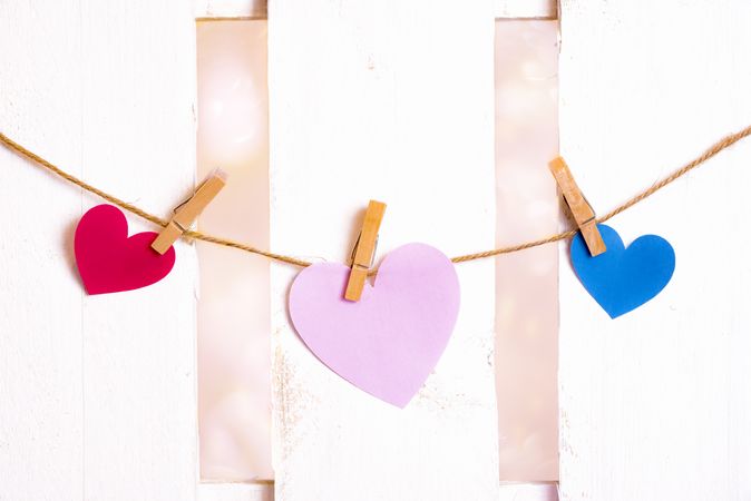 Three paper hearts on a string