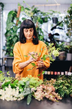 Woman making a flower bouquet.