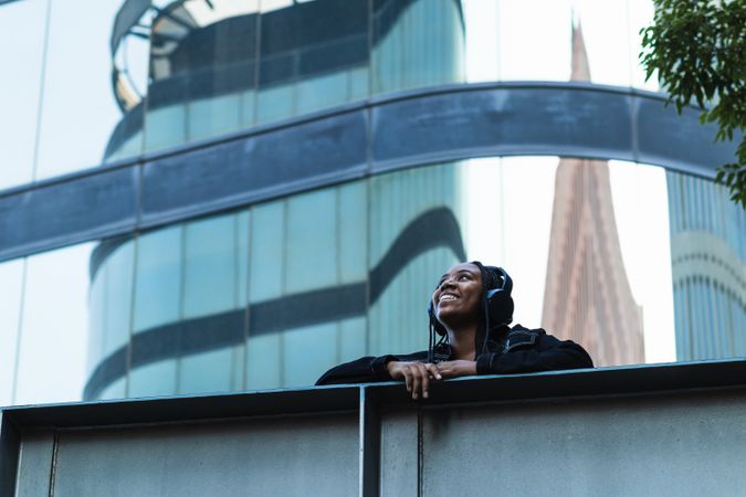 Happy female listening to music on bridge