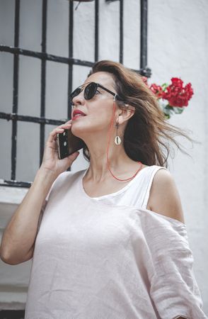 Confident woman calling on phone in town