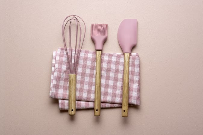 Kitchen utensils on a pink table