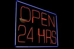 Neon sign open 24 hrs in dark