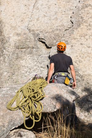 A rock climber is staring at the mountain