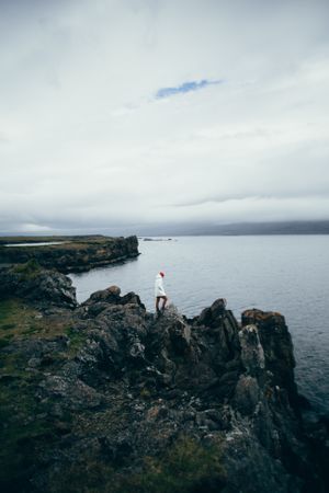 Man on jagged cliff rocks
