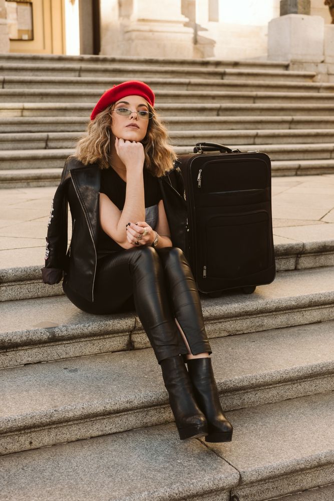 Cheerful tourist drinking on steps