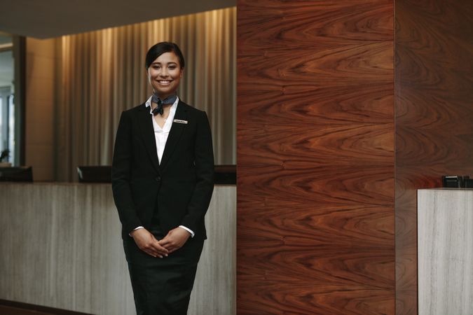 Female standing at hotel front desk