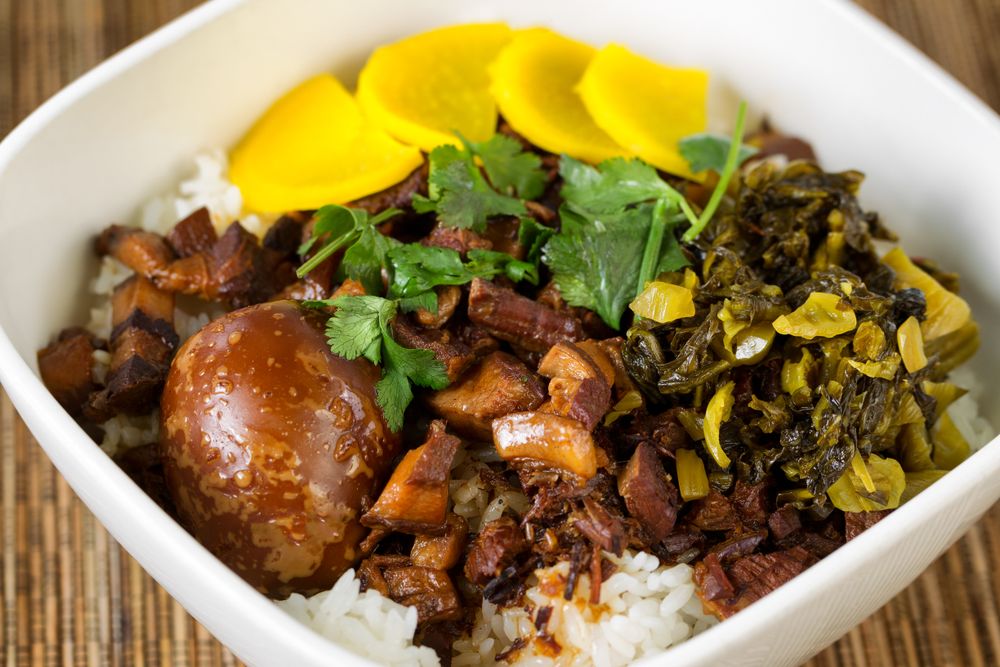 Chinese pork and egg dish with rice in bowl setting