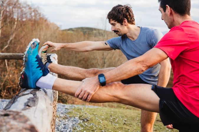 Sportsmen stretching after running in mountains