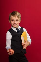 Cute guy hold yellow book and apple