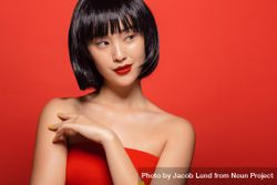 Stylish female model wearing wig against red background 5pqRe4