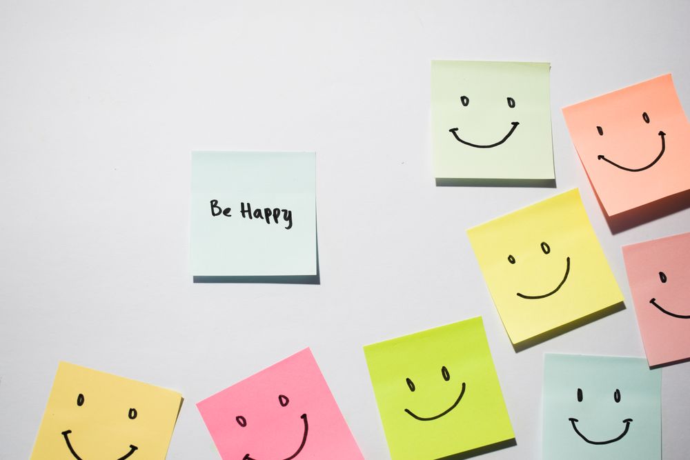 Be Happy and smile emoticon on sticky notes