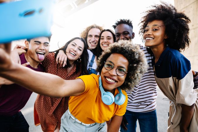 Boisterous fun friends taking selfie outside