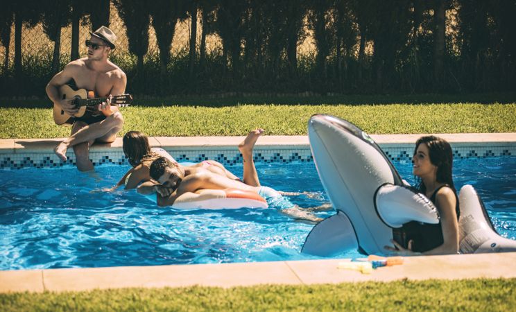 Men and women relaxing in poolside