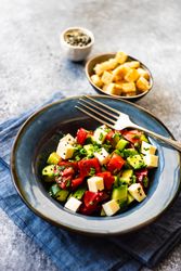 Healthy Greek salad with fresh vegetables and cubed cheese