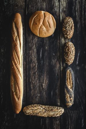 Assorted gold homemade bread on dark wood background