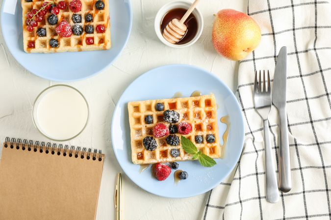 Composition of breakfast with belgian waffles, top view