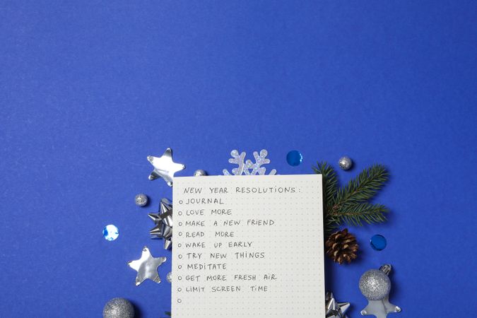 Paper with list and decorations on blue background, space for text
