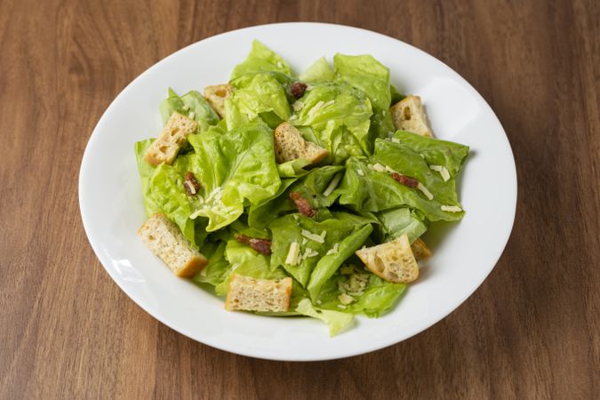 Caesar salad with croutons and bacon.