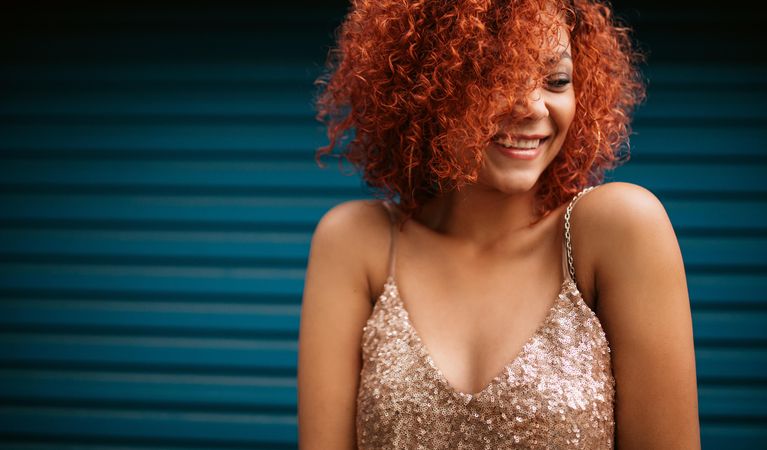 Young woman in golden brown curly hair smiling