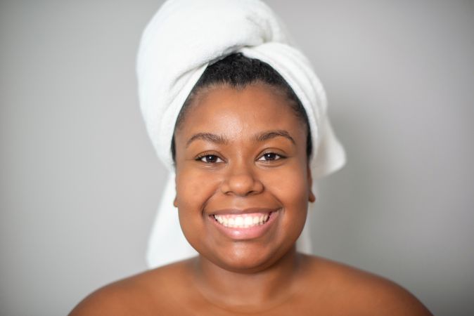 Happy Black woman with towel on head
