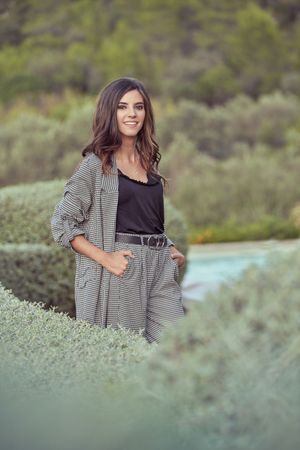 Elegant woman standing in countryside