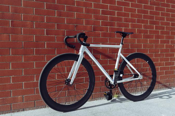 Road bicycle against brick wall