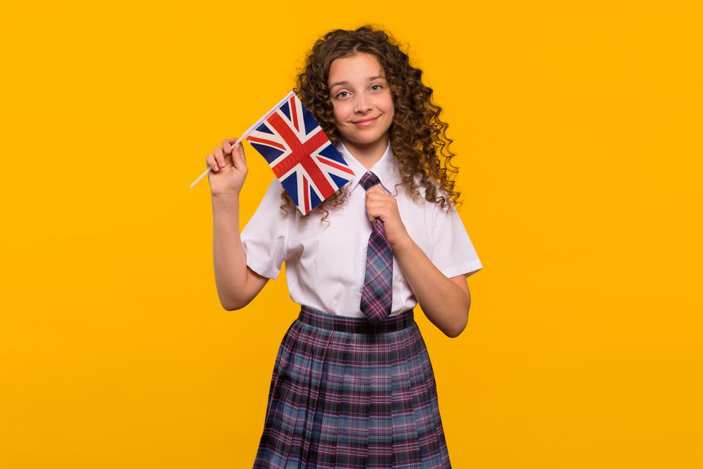 Smiling girl holding a UK flag