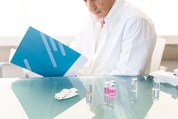 Pensive man writing down results of research
