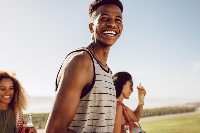 Happy young man hanging out with friends on a summer day