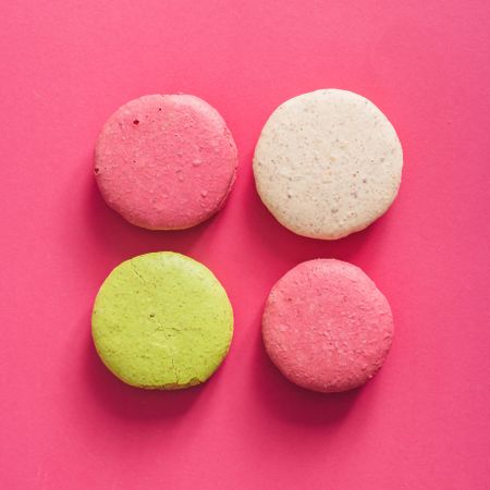 Colorful French macaron on bright pink background