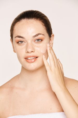 Amiable female taking care of face