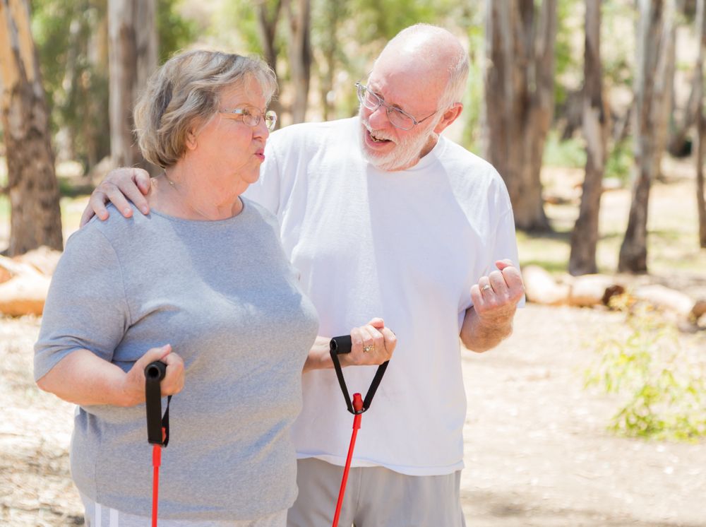 Happy Mature Couple Exercising Outside Together