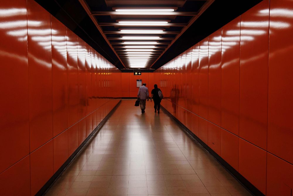 Two people walking in a hallway