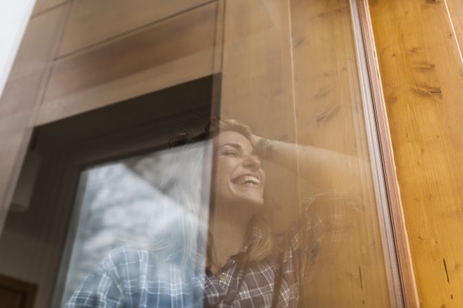 Woman reflection in a windows at home