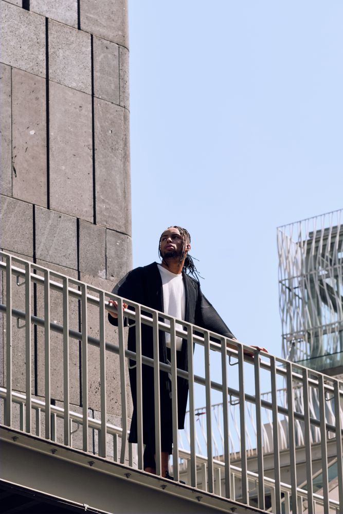 Black male standing on bridge