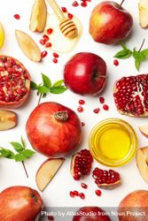 Top view of fresh apples and pomegranates with honey on side with copy space 5rJXZ5