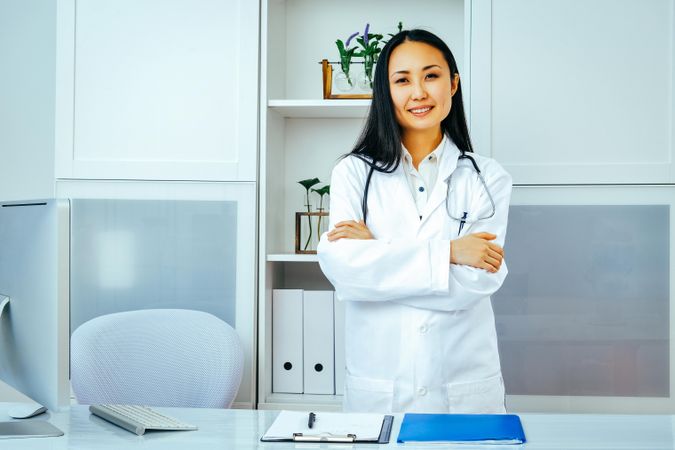 Confident Asian woman doctor in her clinic