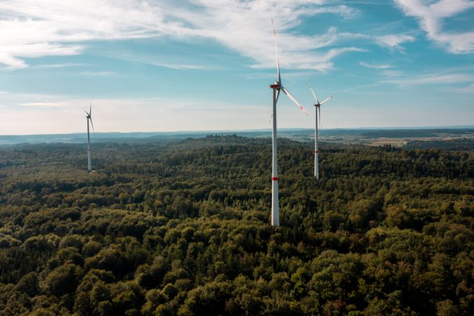 Aerial view image with vast forest and wind turbines, in Baden Wurttemberg region, Germany