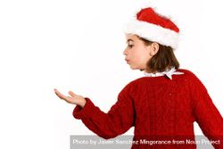 Girl in Christmas outfit with hand up to copy space 0yJa15