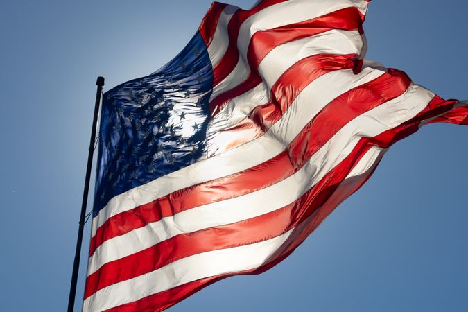 Dramatic Backlit American Flag Waving in the Wind.