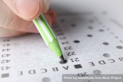 Person with green pencils taking multiple-choice exam 5kJaG0