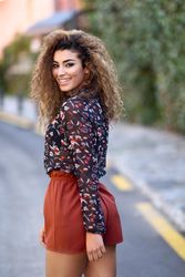 Arab woman looking back while wearing casual clothes in the street