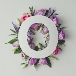 Colorful flowers, leaves and  paper “O”