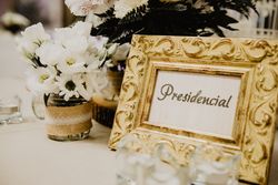Photo frame near flowers on table