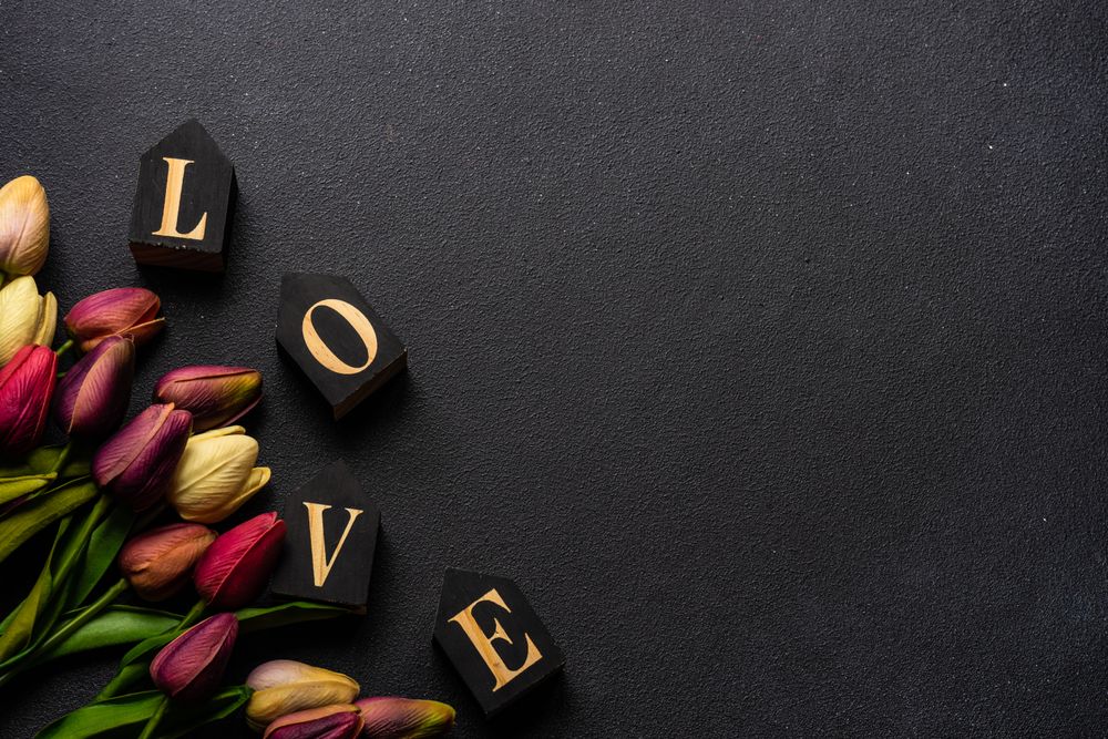 Tulips and the word "love" on dark counter